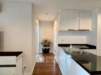 Modern kitchen with sleek countertops and elegant hallway view