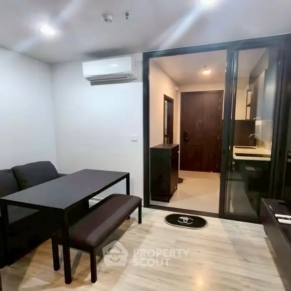 Modern living room with sleek furniture and air conditioning in a stylish apartment.