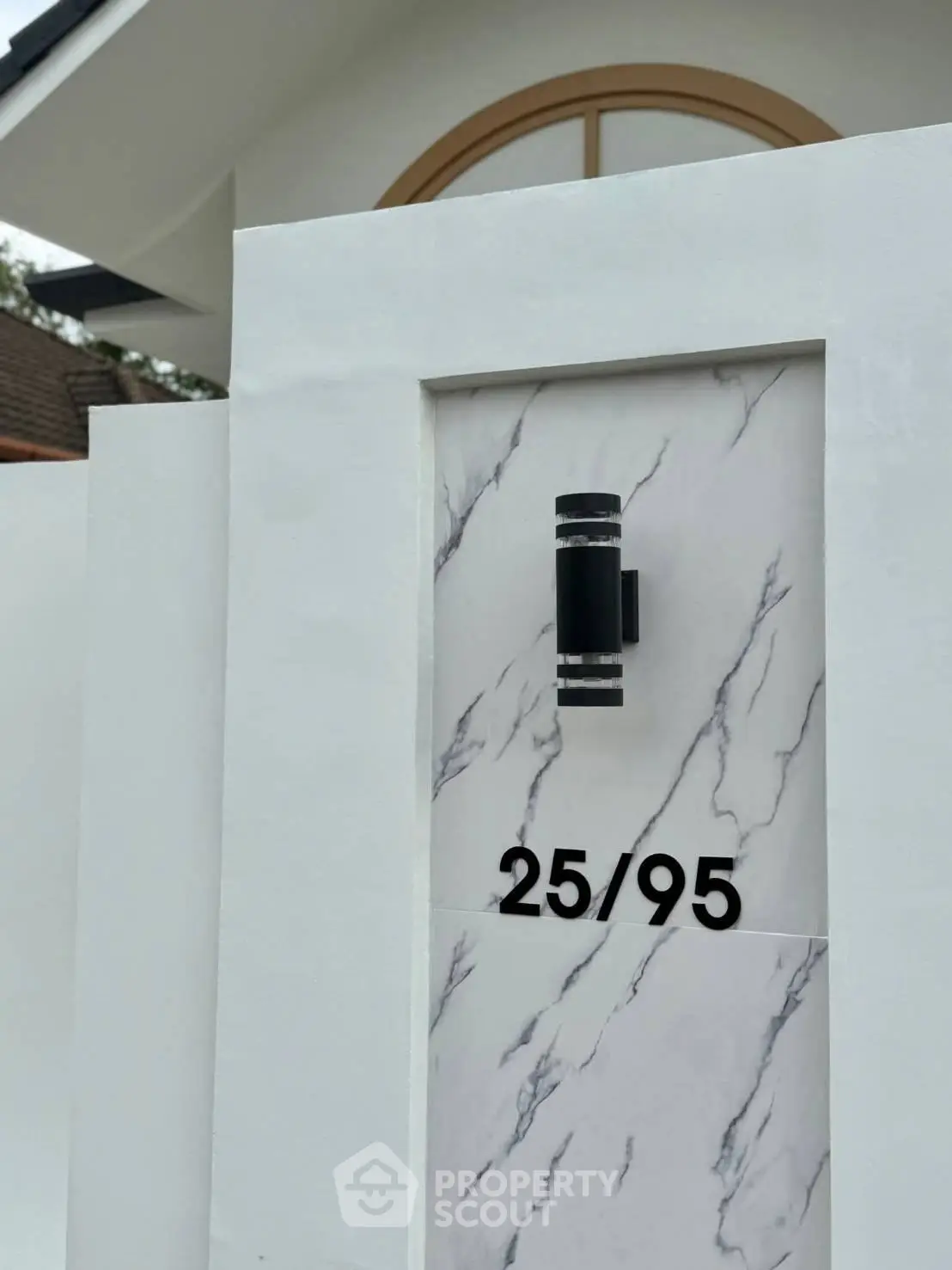 Modern house entrance with stylish marble accent and unique address display