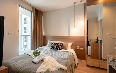 Modern bedroom with cozy decor and mirrored wardrobe in a stylish apartment.