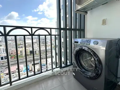 High-rise balcony with city view and washing machine, perfect for urban living.