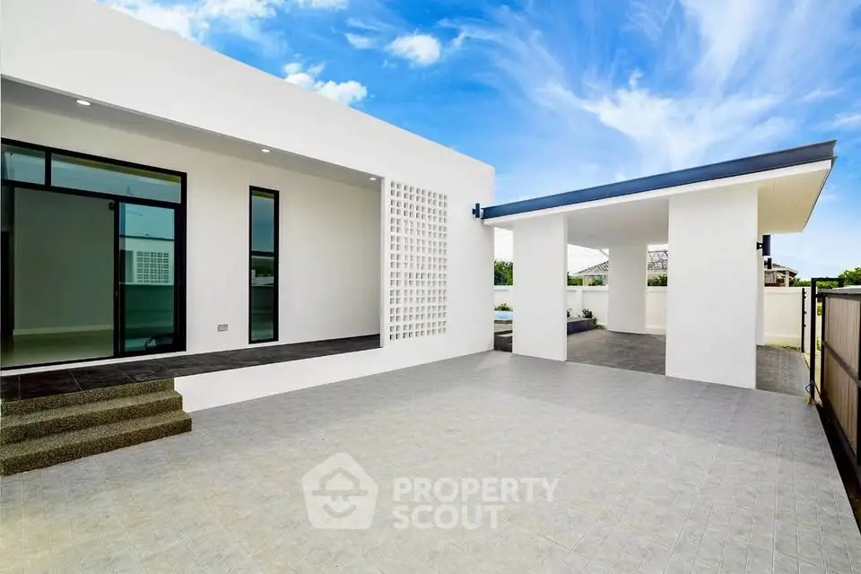 Modern minimalist home exterior with spacious patio and sleek architectural design.