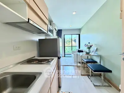 Modern apartment kitchen with open layout and scenic balcony view