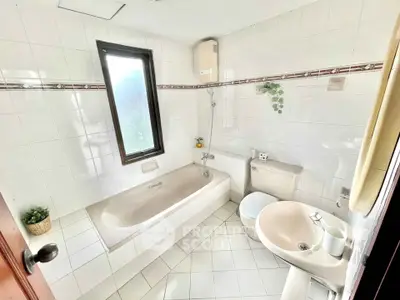 Bright and airy bathroom with bathtub and modern fixtures in a stylish home.