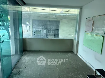 Spacious commercial space with large glass windows and street view, ideal for retail or office use.