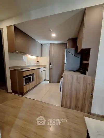 Modern kitchen with sleek cabinetry and built-in appliances in a stylish apartment.
