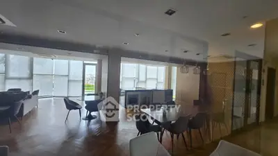 Spacious modern living and dining area with open kitchen and stylish furniture.