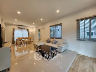 Spacious modern living room with elegant dining area and natural light
