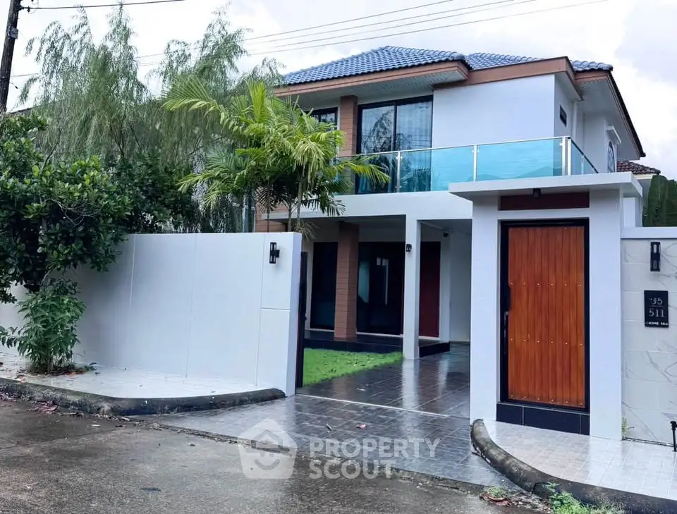 Modern two-story house with sleek design and spacious driveway in a serene neighborhood.
