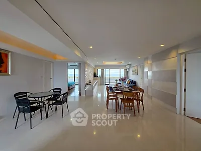 Spacious modern living room with ocean view and elegant dining area