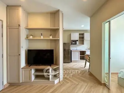 Modern living room with TV and open kitchen in stylish apartment