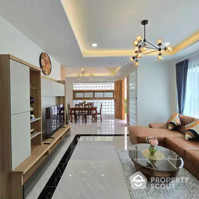 Modern living room with stylish furniture and elegant lighting in a spacious open layout.