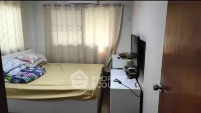 Cozy bedroom with natural light and modern furnishings, perfect for restful nights.