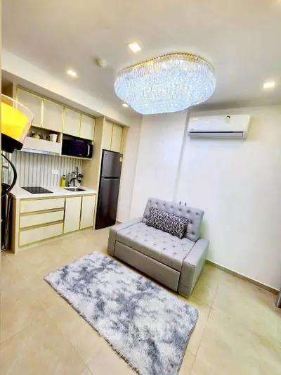 Luxurious living room with elegant chandelier and modern furnishings in a stylish apartment.