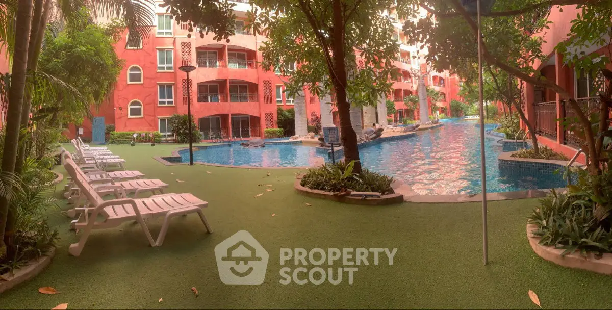 Luxurious apartment complex with stunning pool and lush greenery, perfect for relaxation and leisure.