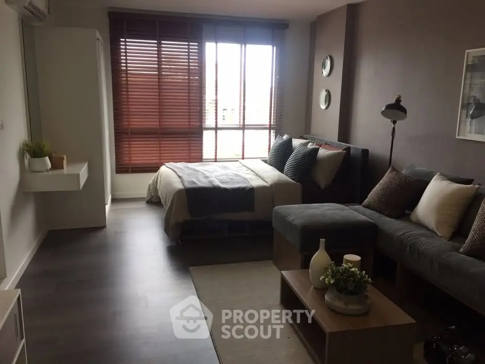 Modern studio apartment with cozy living area and stylish decor