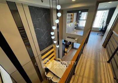 Modern duplex apartment with stylish lighting and open layout, featuring a mezzanine and large windows for natural light.