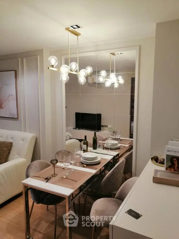 Elegant dining area with modern chandelier and stylish decor in a cozy apartment setting.