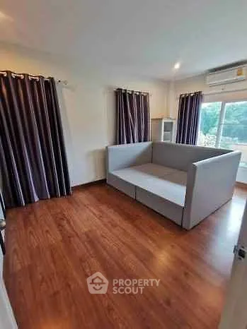 Spacious living room with modern sofa and hardwood floors