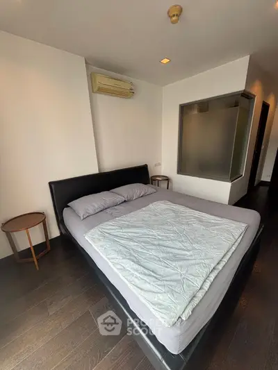 Modern bedroom with sleek design and air conditioning in a stylish apartment.