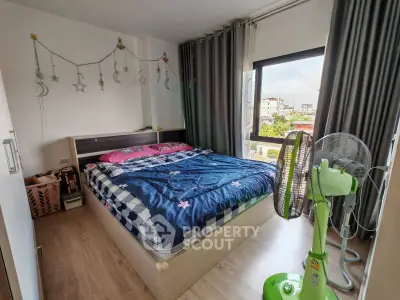 Cozy bedroom with large window and stylish decor in modern apartment