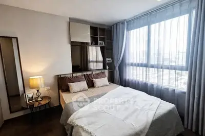 Modern bedroom with large window and stylish decor in urban apartment