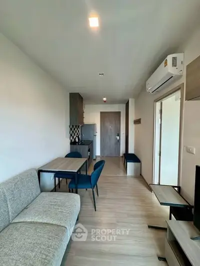 Modern living room with sleek furniture and air conditioning in a stylish apartment.