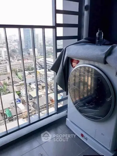 High-rise balcony with city view and modern washing machine, perfect for urban living.