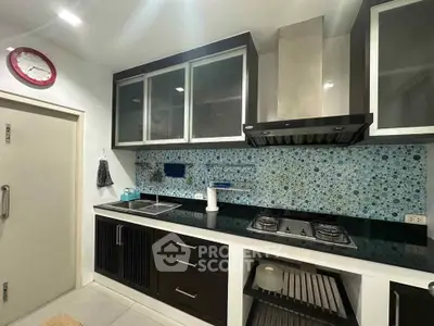 Modern kitchen with sleek cabinetry, gas stove, and stylish backsplash