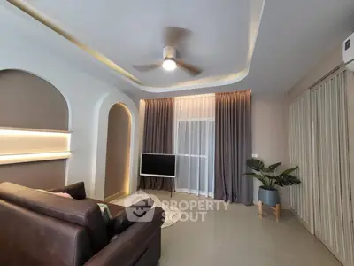 Modern living room with stylish ceiling fan and cozy lighting