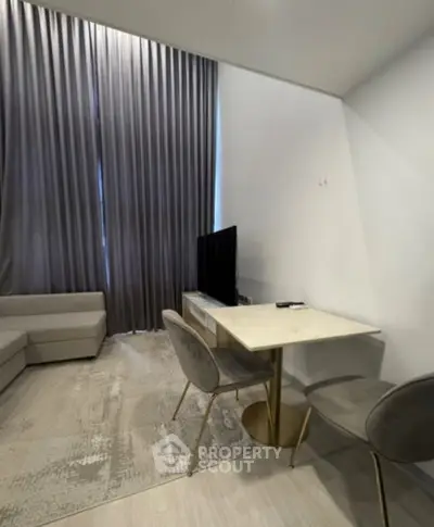 Modern living room with elegant furniture and floor-to-ceiling curtains