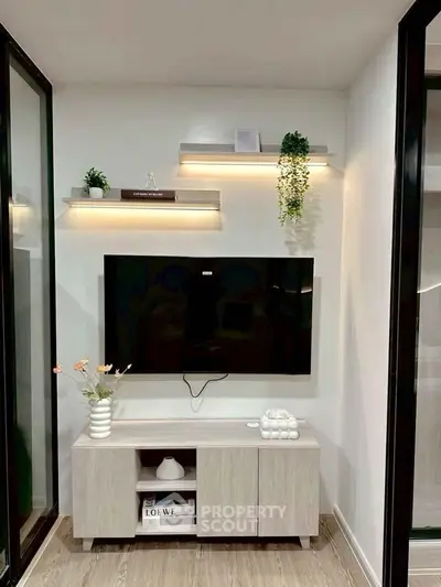 Modern living room with wall-mounted TV and stylish shelves