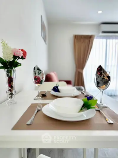 Elegant dining setup in modern living room with natural light and stylish decor.