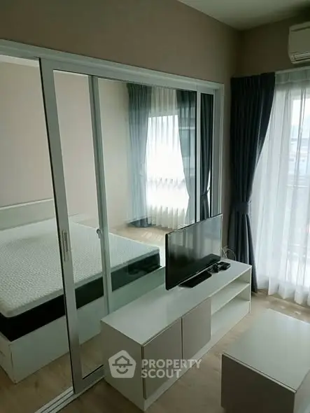 Modern bedroom with sliding glass doors and natural light