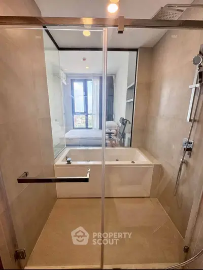 Modern bathroom with glass shower and bathtub in luxury apartment