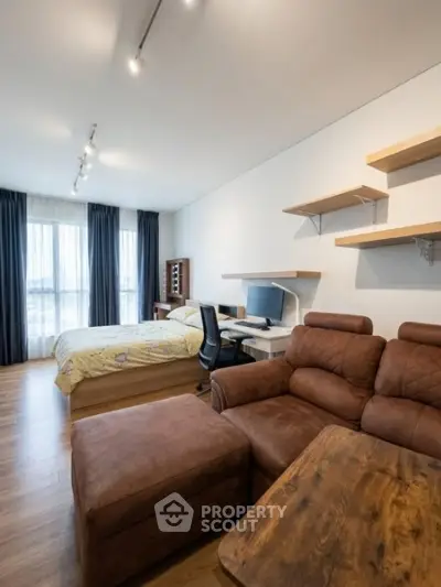Modern studio apartment with cozy living area and workspace
