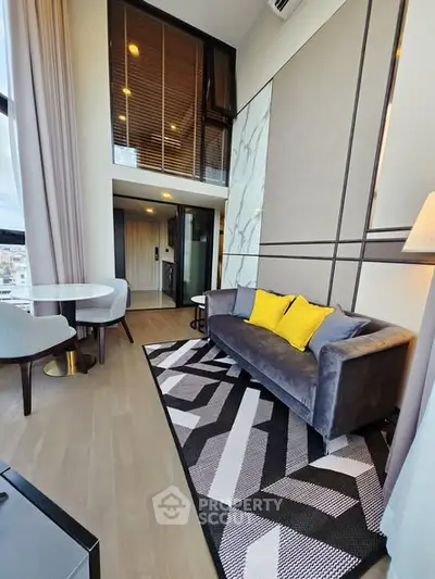 Modern living room with high ceilings, stylish decor, and a mezzanine level in a luxury apartment.