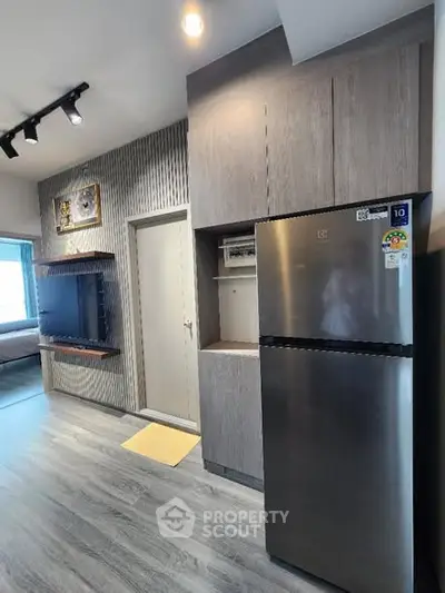 Modern kitchen with sleek fridge and stylish cabinetry