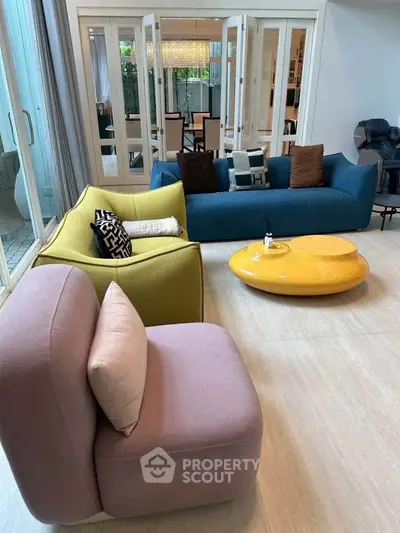 Stylish modern living room with colorful sofas and elegant decor