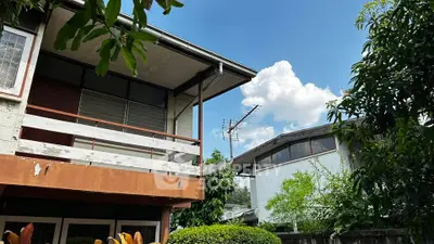 Charming suburban home with lush greenery and clear blue sky, perfect for tranquil living.