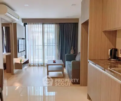 Modern open-plan living room with natural light and stylish wooden finishes.