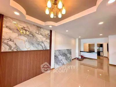 Spacious modern living room with elegant marble accents and stylish lighting