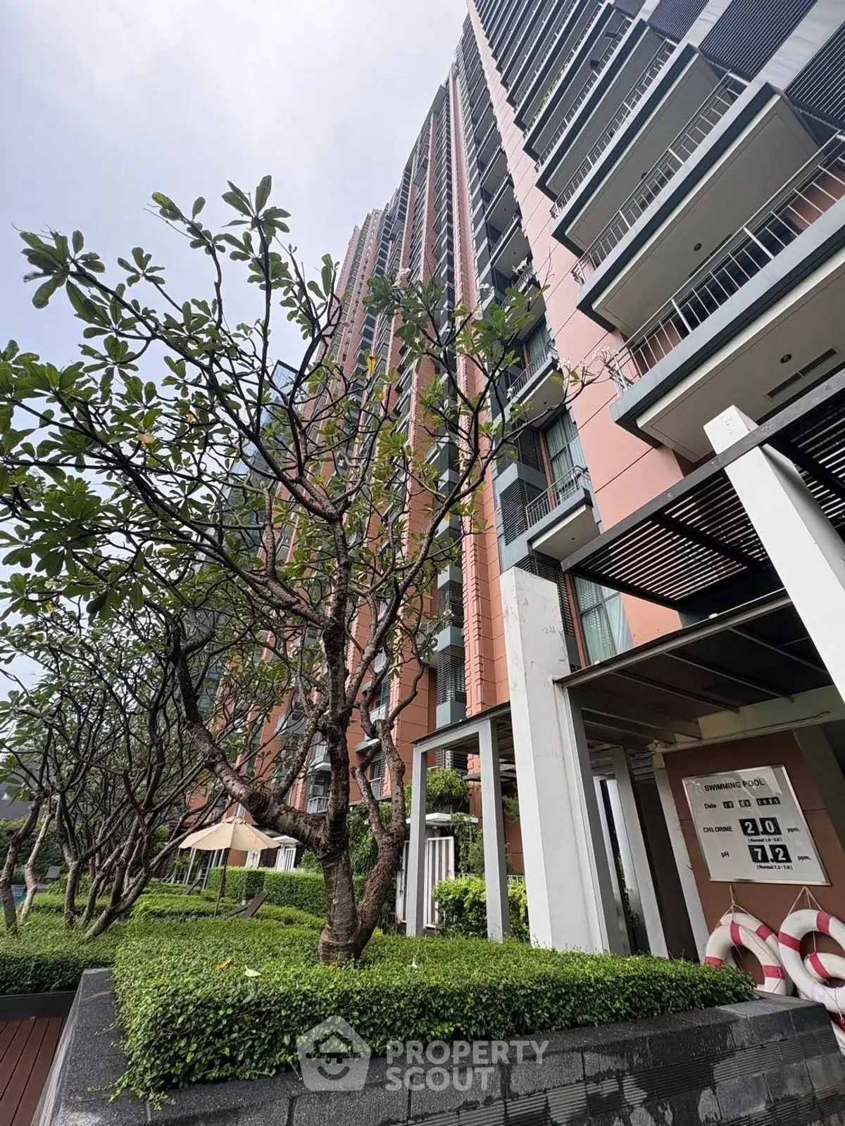 Modern high-rise building with lush greenery and contemporary design