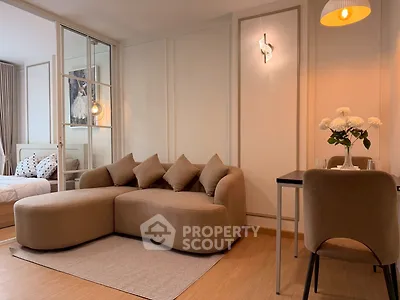 Modern living room with cozy sofa and stylish decor in open-plan apartment
