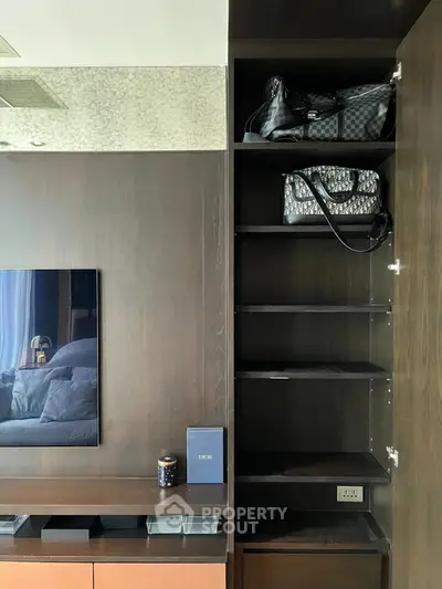 Modern living room with sleek shelving and luxury bags, showcasing elegant interior design.