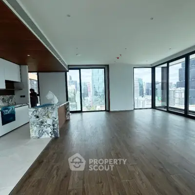 Luxurious open-plan living room with stunning city views and modern kitchen design.