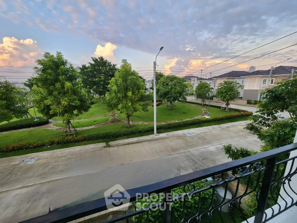 Charming suburban neighborhood view from balcony with lush greenery and serene atmosphere.