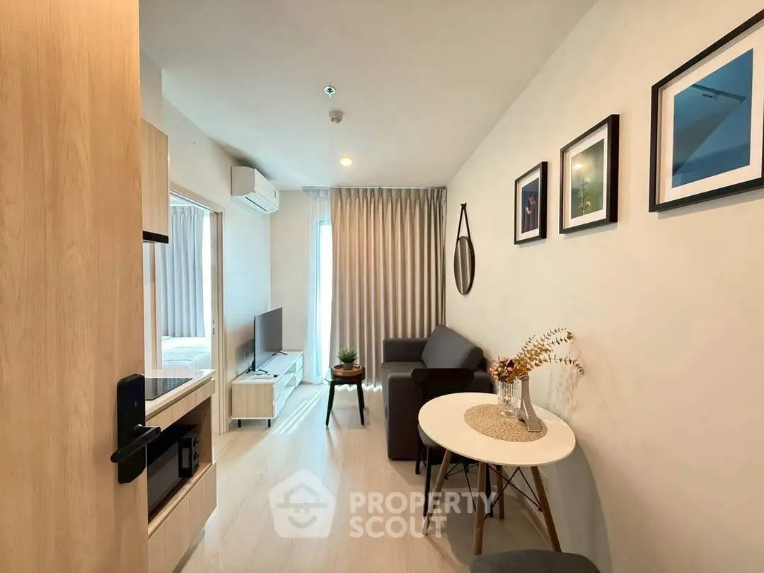 Modern living room with cozy decor and natural light in a stylish apartment.