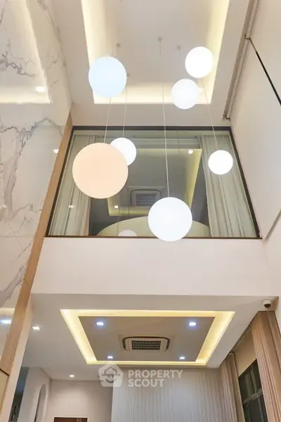 Modern interior with high ceiling and stylish lighting in a luxurious home