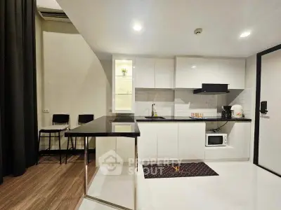 Modern kitchen with sleek white cabinets and breakfast bar in stylish apartment